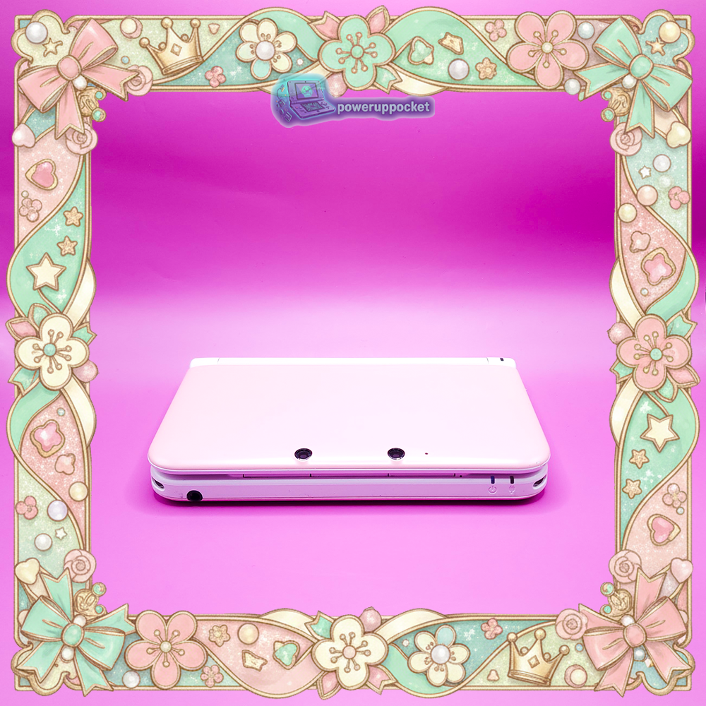 Front closed view of a custom Nintendo 3DS XL with pink shell and white hinge, photographed on a pink background.