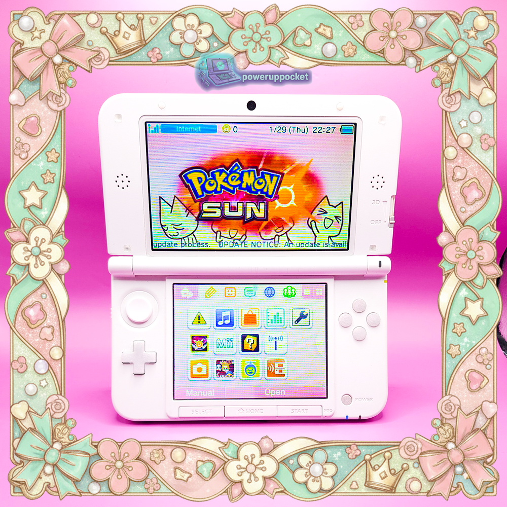 Custom Nintendo 3DS XL with pink shell and pearlescent white buttons shown open from the front, screens on, photographed on a pink background by PowerUpPocket.