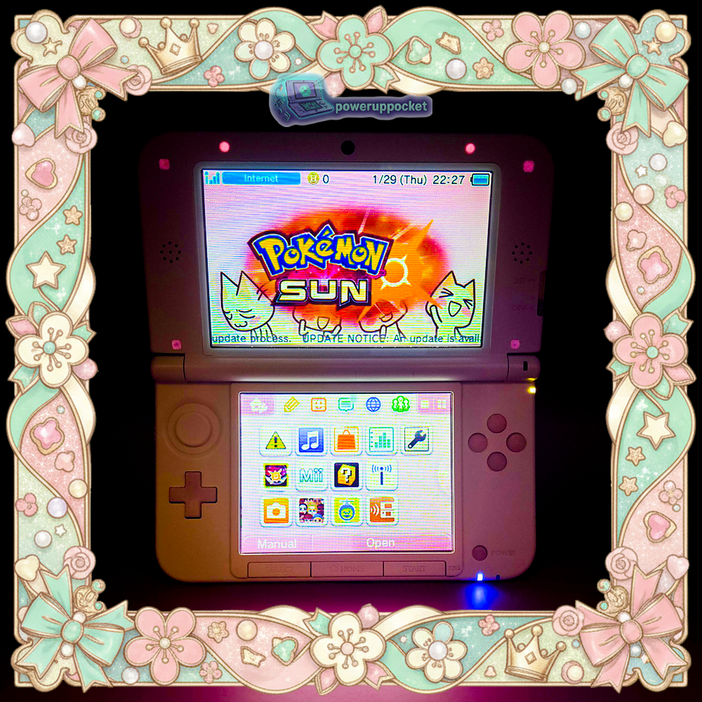 Custom Nintendo 3DS XL with pink shell and white controls shown open in low light, highlighting glow in the dark rubber accents around the top screen and back plate.